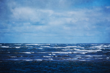 Rolling waves on a deep blue ocean.  With added texture.