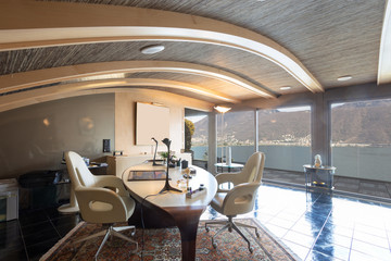 Modern studio with white leather chairs