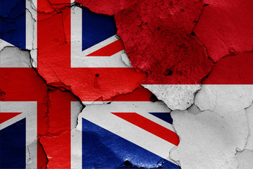 flags of UK and Indonesia painted on cracked wall