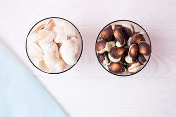 Seashell and chocolate sweets on wooden background 