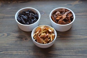 Various dried fruit displayed on an old wooden table.
