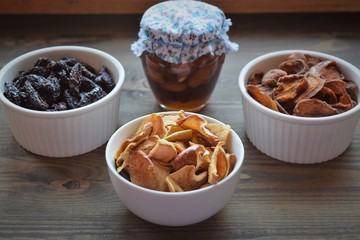 Various dried fruit displayed on an old wooden table.