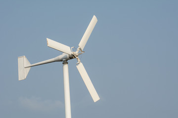 Wind turbine isolated on blue sky background