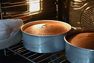 Close up of baking chocolate cakes in the hot oven, homemade cake.