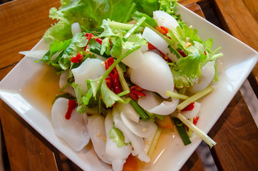 Thai food, squid salad, consisting of squid, chili, vegetables, celery and tomatoes, sour taste, spicy.