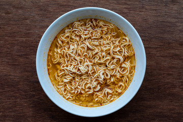 instant noodles is one on a wood brown background with copy space, Quick cooking
