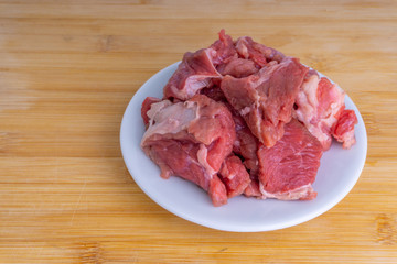 Fresh raw beef steak on wooden background with selective focus