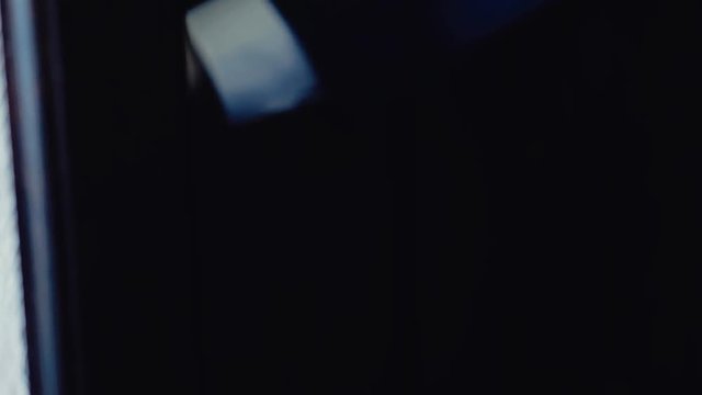 close up person passes into the hotel room, before inserting a key card into the lock.