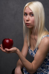 Fototapeta na wymiar beautiful girl in a fashionable dress with apple