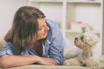 Dog and owner on the sofa in home