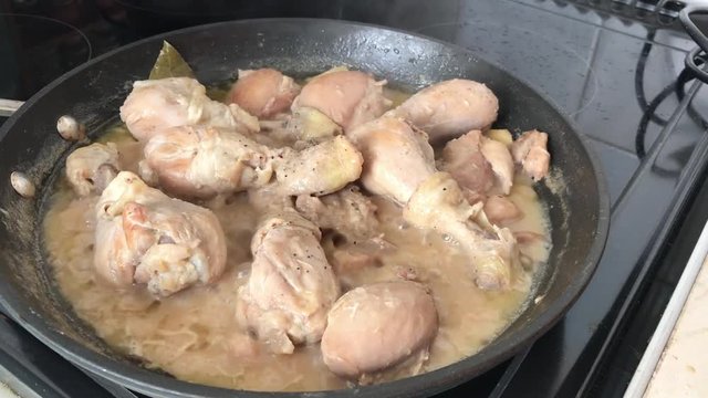 Chicken adobo cooking in a pan