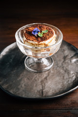 Tiramisu in glass cup is a coffee-flavoured Italian dessert. It is made of ladyfingers dipped in coffee, layered with a whipped mixture of eggs, sugar, and mascarpone cheese, flavoured with cocoa.