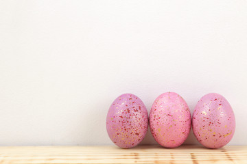 Easter. Pink Easter eggs on a natural wooden table. Happy easter. holidays. free place