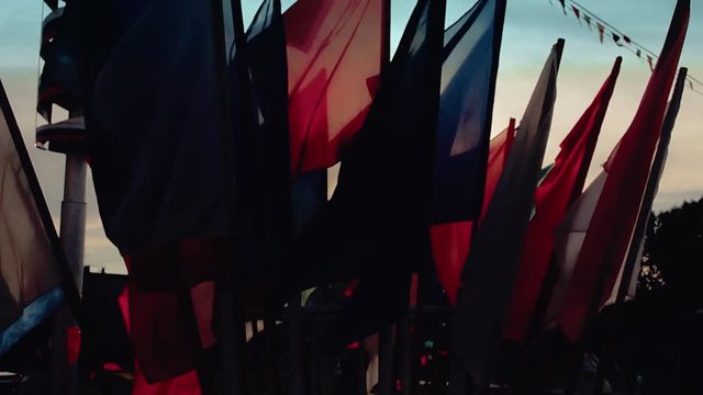 Multicolored flags fluttering on the wind close up