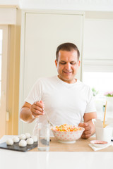 Middle age man eating asian food at home