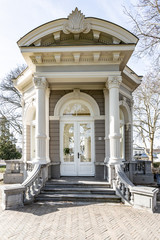 The entrance of the Tea dome or Gloriette with a stone staircase with neoclassical decoration in the Proosdij park, wonderful sunny winter day in Meerssen south Limburg in the Netherlands Holland