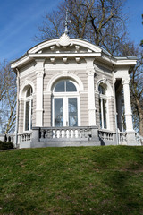 Fototapeta na wymiar The Tea dome or Gloriette with its arched windows with pillars and a stone railing on a hill in Proosdij park, wonderful sunny winter day in Meerssen south Limburg in the Netherlands Holland