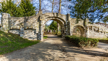 Old stone bridge with two arches, a dirt road in the Proosdij park, wonderful and sunny day in Meerssen south Limburg in the Netherlands Holland