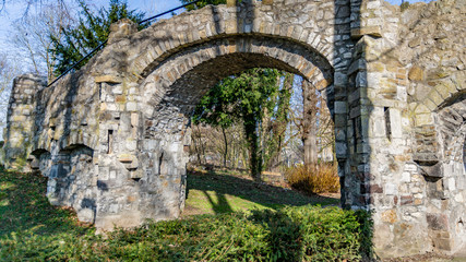 Fototapeta na wymiar Old stone bridge with two arches, a dirt road in the Proosdij park, wonderful and sunny day in Meerssen south Limburg in the Netherlands Holland