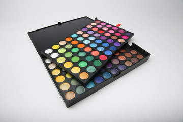 professional eyeshadow set consisting of several palettes isolated on white background. cosmetic accessories on white background. eye shadow palette for colorful makeup.