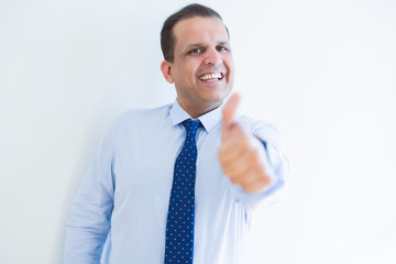 Middle age man doing postive gesture with thumbs up smiling to the camera
