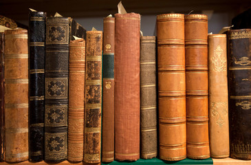 Vintage bookshelf with many books in leather covers, printed at 19th century and before. Knowledge...