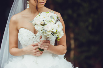 beautiful bride holding wedding bouquet
