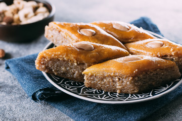 Baklava. Ramadan Dessert. Traditional Arabic dessert with nuts and honey on a wooden table