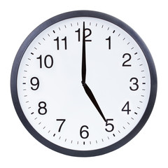 Round office clock showing five o'clock isolated on white background