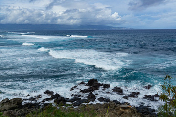Fototapeta na wymiar Big waves on one of Maui's surfing beaches along the road to Hana.