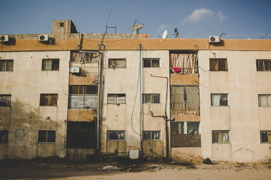 third world country poor dirty slum house facade in vintage old style photography in ghetto Middle East district 