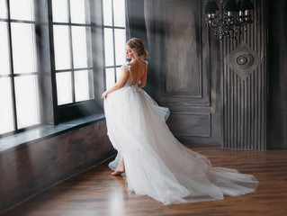 charming angel in snow-white dress dancing in castle tower with large windows, a new story about...