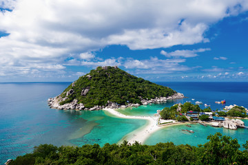 Panoramic aerial view of tropical island in Thailand against blue sky with clouds. 