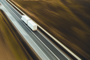 Obraz na płótnie Canvas White truck transport goods street road highway
