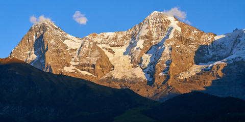 Panoramic mountain view of Monch, Eiger at sunset in Switzerland.