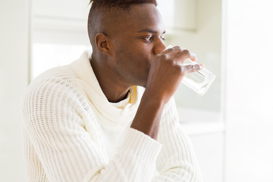 Young african american man drinking a fresh glass of water