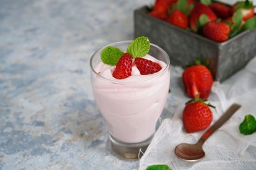 Homemade Strawberry Mousse topped with berries and mint leaf garnish, selective focus