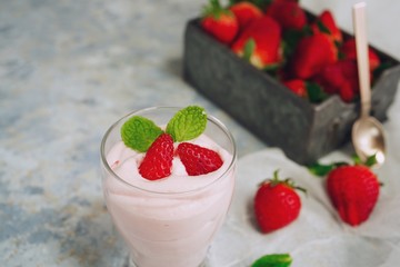 Homemade Strawberry Mousse topped with berries and mint leaf garnish, selective focus