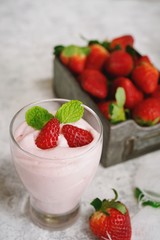 Homemade Strawberry Mousse topped with berries and mint leaf garnish, selective focus
