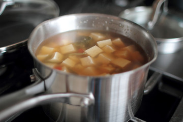 Pot of vegetarian soup with tofu and vegetables.