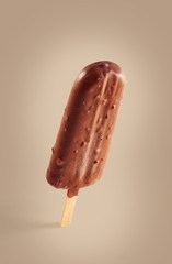 Chocolate covered ice cream on a brown background