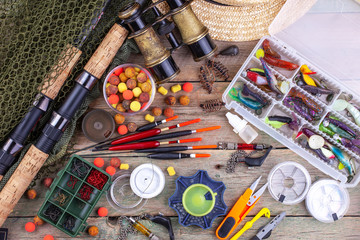 fishing tackle on a wooden table. toned image 