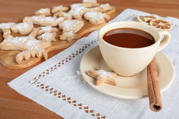 Cup of hot chocolate and homemade ginger cookies on wooden table