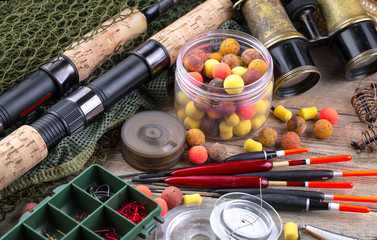 fishing tackle on a wooden table. toned image 