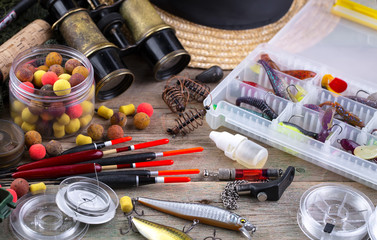 fishing tackle on a wooden table. toned image 