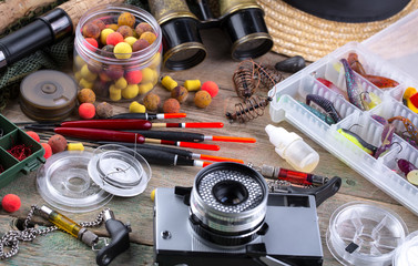 fishing tackle on a wooden table. toned image