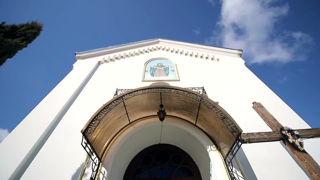 An old little church, and next to high tui that flutter from the wind