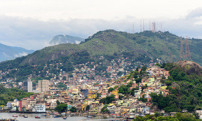 Naklejka premium Aerial view of the beautiful city of Vitoria, Espirito Santo, Brazil and its wide bay. The city developed with its high buildings growing on the hills and into the local greenery