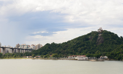 Obraz premium Aerial view of the beautiful city of Vitoria, Espirito Santo, Brazil and its wide bay. The city developed with its high buildings growing on the hills and into the local greenery