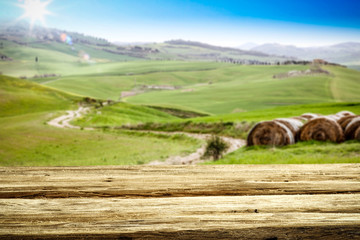 Spring background of table and Tuscany landscape 